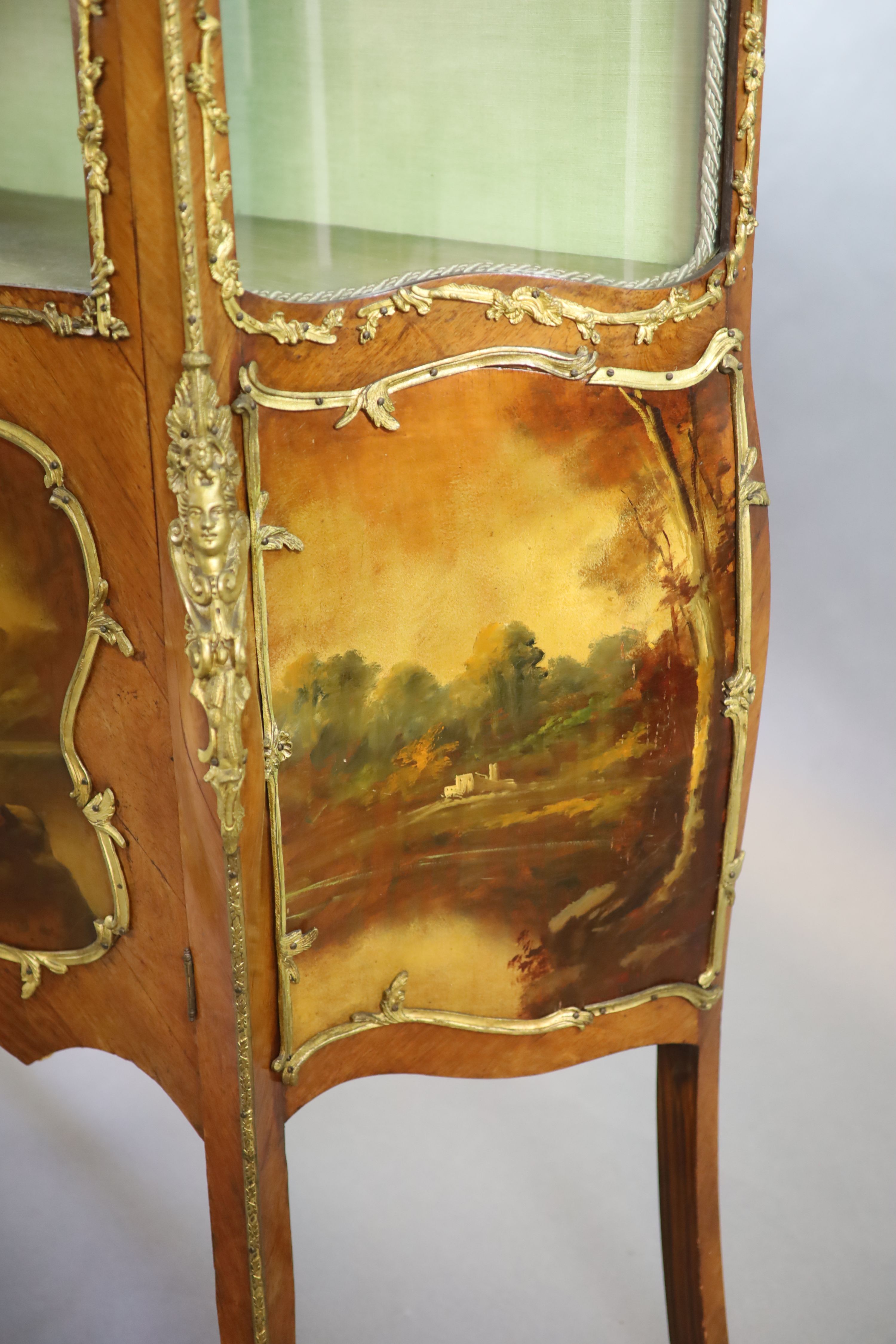 A Louis XV style mahogany vitrine, 76cm wide, 38cm deep, 194cm high.